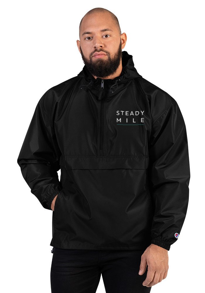 Packable Wind Layer in Black with the embroidered Pathmark Steady Stack on the chest